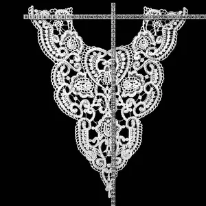 Detailed view of white water-soluble lace collar embroidery showing dimensions on ruler.