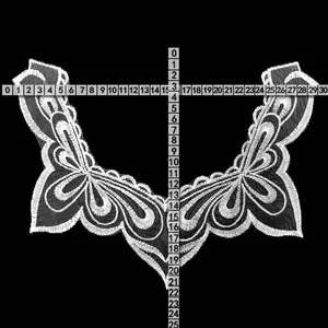 Detailed view of white embroidered water-soluble lace collar with measurement scale