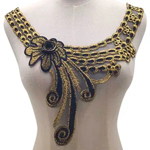Detailed view of elegant gold and black embroidered lace collar applique on mannequin