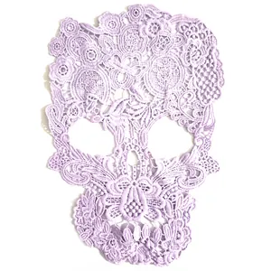 Macro view of purple lace skull applique showing intricate floral embroidery detail