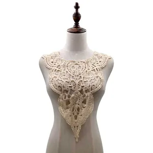 Close-up of beige water-soluble lace collar with intricate floral embroidery details.