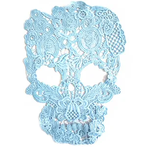 Detailed view of light blue skull embroidery patch with intricate floral lace
