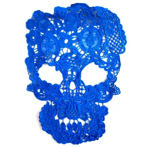 Detail view of intricate blue skull-shaped water-soluble lace embroidery patch for DIY