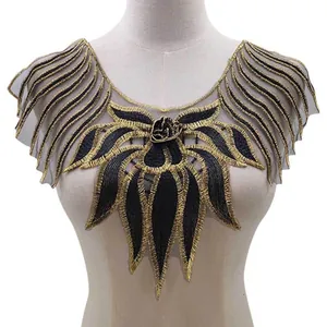 Close-up of elegant black and gold embroidered lace collar applique shown on a mannequin