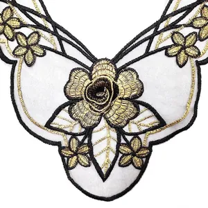 Detail view of black and gold rose lace embroidery collar applique on white background