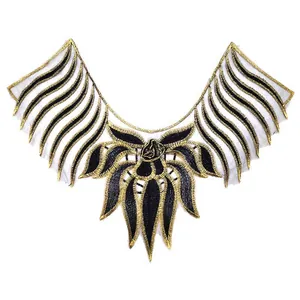 Macro view of gold and black embroidered water-soluble lace collar applique