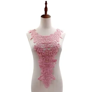 Close-up detail of a delicate pink water-soluble lace collar applique on a white mannequin