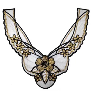 Detailed macro view of gold and black floral embroidery lace neckline patch