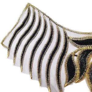 Close-up of black and gold embroidered lace collar applique for DIY fashion clothing craft.
