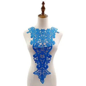 Detail view of bright blue water-soluble lace neck applique with intricate embroidery