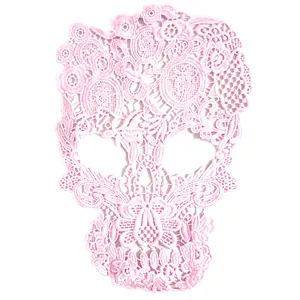 Detailed view of an intricate pink skull lace embroidery patch for DIY sewing crafts