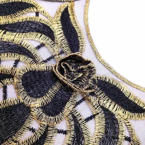 Close-up detail of black and gold embroidered water-soluble lace collar flower applique