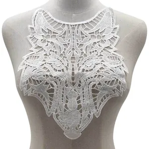 Detailed macro view of white wolf head lace applique featuring intricate 3D embroidery