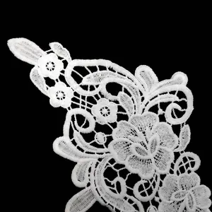 Close-up of intricate white water-soluble lace flower embroidery with hollowed details
