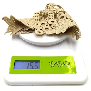 Close-up detail of beige water-soluble lace collar showing a precise weight of 15.5 grams