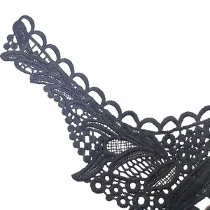 Detail view of intricate black water-soluble lace embroidery for faux collar decoration