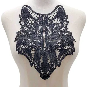Detailed view of a black wolf head water-soluble lace embroidery patch on mannequin