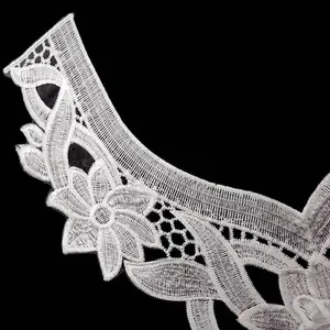 Close-up detail of a white water-soluble lace collar featuring intricate floral embroidery