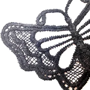 Close-up of black water-soluble lace butterfly embroidery showing intricate detail
