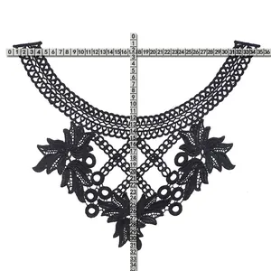 Close-up of black water-soluble lace collar embroidery patch with measurement scales