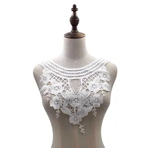 Intricate detail of white water-soluble lace floral collar embroidery on mannequin
