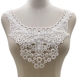 Close-up of elegant white floral lace false collar with delicate pearl bead accents