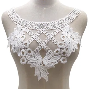 Detailed view of a white water-soluble lace collar featuring intricate floral embroidery