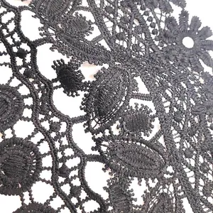 Detailed macro view showing the intricate floral embroidery of black water-soluble lace fabric
