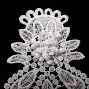 Macro view of multi-layered white milk silk embroidered lace flower applique with 3D texture
