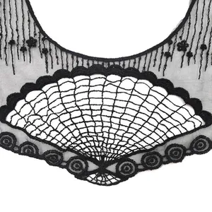 Close-up detail of black fan-shaped embroidered lace applique with mesh base