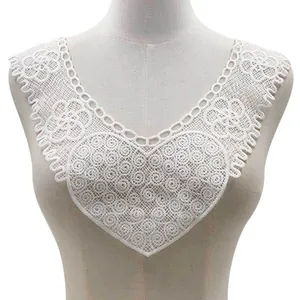 Detailed view of white water-soluble lace embroidered fake collar on mannequin