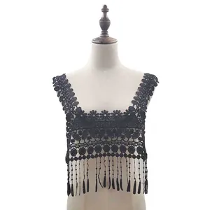 Detail view of black water-soluble lace collar with intricate embroidery and hanging tassel fringe