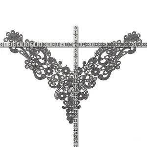 Detailed macro view of grey water-soluble lace collar embroidery with measurement rulers