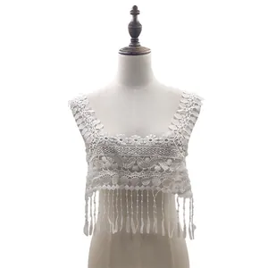 Close-up of white water-soluble lace collar with tassel fringe displayed on a mannequin.