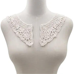 Close-up of white water-soluble lace collar with intricate cotton embroidery
