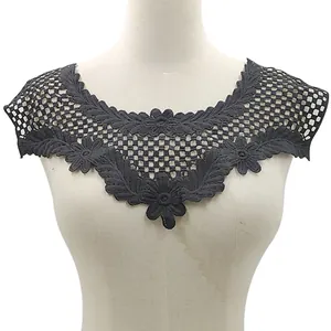Detailed texture of black water-soluble lace collar with floral hollow embroidery