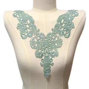 Detail view of mint green water-soluble lace collar with intricate floral embroidery pattern