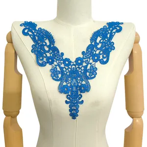 Close-up detail of blue water-soluble lace collar with floral embroidery pattern