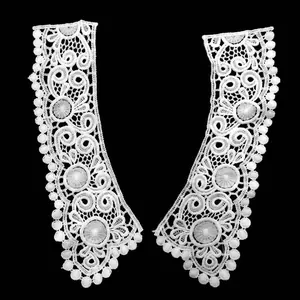 Macro detail of white water-soluble lace collar with 3D hollow embroidery patterns