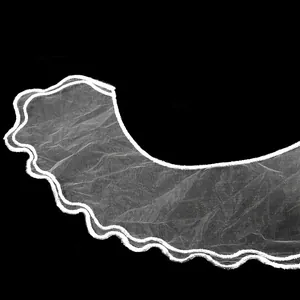 Detail of white double-layered embroidered organza lace collar for elegant dress decoration