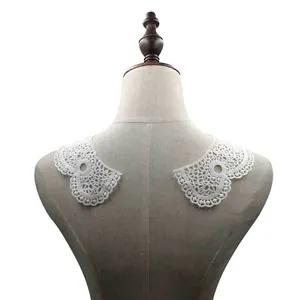 Detailed view of white water-soluble lace collar patch with intricate hollow embroidery