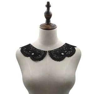 Close-up of black water-soluble lace collar with intricate hollow embroidery