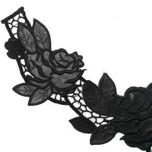 Detailed close-up of black PU leather rose embroidery and water-soluble lace patch