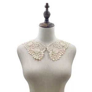 Detailed view of an elegant beige lace collar accessory on a mannequin bust