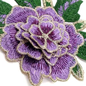 Macro detail of 3D purple rose embroidery patch with multi-layer texture and gold trim