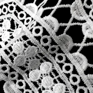 Macro view of intricate white milk silk water-soluble lace embroidery texture for DIY sewing