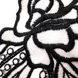 Close-up of black and white milk silk embroidered lace patch with hollow design