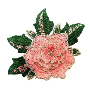 Close-up showing the intricate texture of pink embroidered rose patch with gold edging