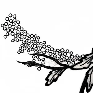 Detailed macro view of black and white hollow water-soluble lace embroidery applique
