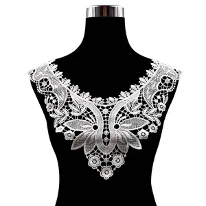 Close-up detail of white water-soluble floral lace collar applique on black mannequin